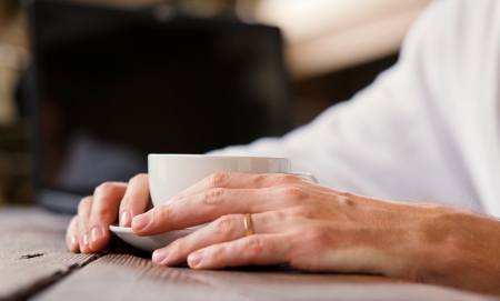 Man hands close up image with cup of morning coffeeの写真素材