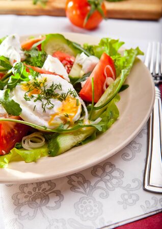 Fresh healthy food. Light green salad with poached eggの写真素材