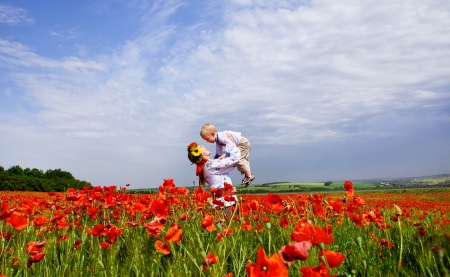 Happy ukrainian mother with son on the poppies fieldの写真素材