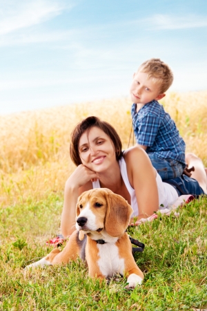 Mother and son have a nice leisure moment on the walk with his petの写真素材