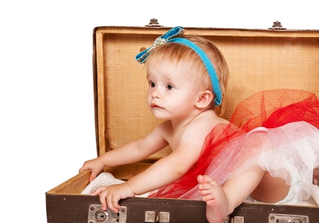 Sweet baby girl sitting  in the old suitcaseの写真素材