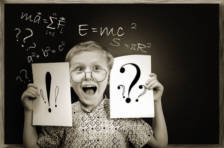Emotional screaming pupil boy over green chalkboard backgroundの写真素材