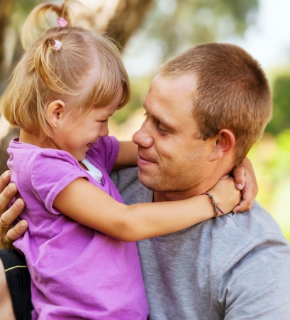 Daughter tender hugs her fatherの写真素材