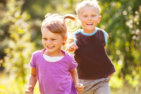 Happy children playing  catch-up gameの写真素材