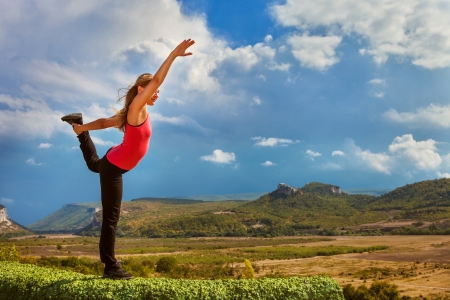 Yoga outdoor. Beautiful slim girl do  King of dance yoga poseの写真素材