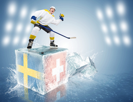 Spunky hockey player on ice cube of Sweden - Switzerland gameの写真素材