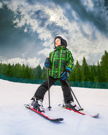 Little skier in mountain sky resortの写真素材