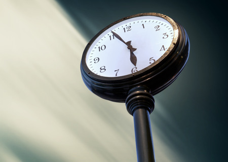 Big street Clock on the blurred sky backgroundの写真素材