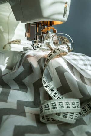 Taylor workplace: sewing machine , fabric and sewing meterの写真素材