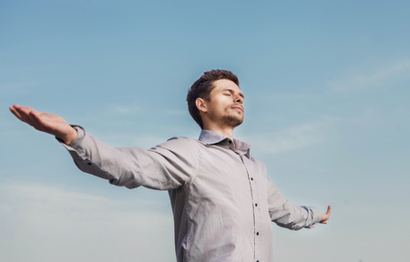 Calm young man portrait over blue sky