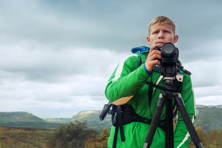 Photographer man in mountainの写真素材
