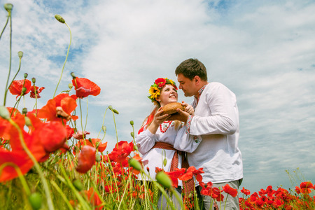 Happy ukrainian couple on the blossom fieldの写真素材