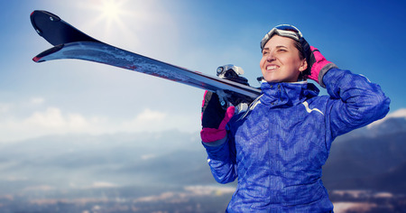 Woman with snowboard on the snow mountain panorameの写真素材