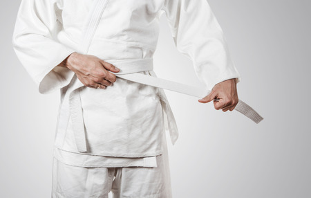 Judoka tying the white belt (obi)の写真素材