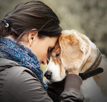 Woman with her dog tender sceneの写真素材