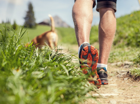 Man legs on the mountain footpath close up imageの写真素材