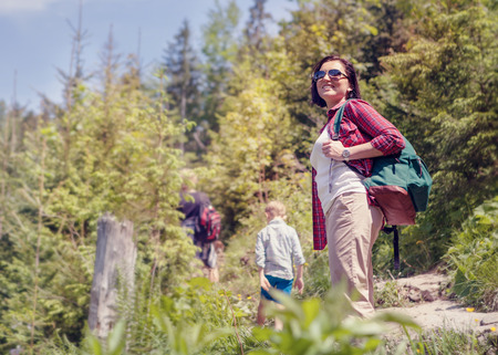 Active family walk in mountain forestの写真素材