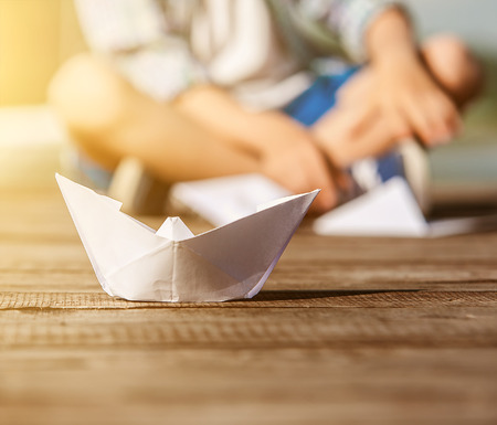 Close up image paper ship on the wooden pierの写真素材