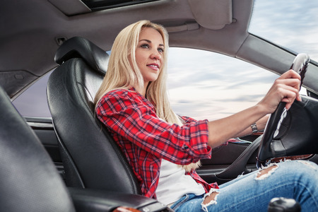 Young blonde drive a carの写真素材