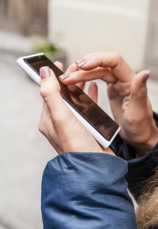Woman hands with telephone close up imageの写真素材