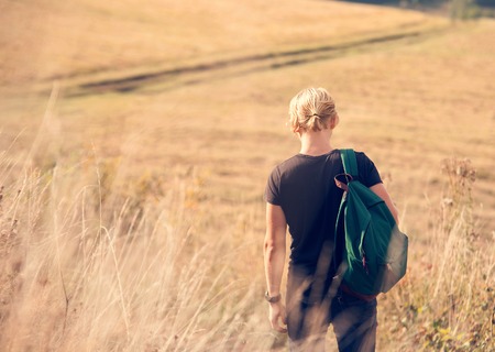 Young man walk on country side