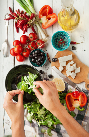 Vegetarian low calorie Greek salad preparation top view Vegetarian low calorie Greek salad preparation top view