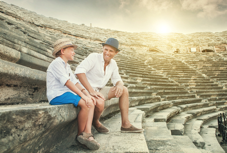 Father and son spent time together on antique ruins amphitheaterの写真素材