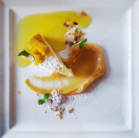 Pumpkin cheescake with orange dressing and almond nutsの写真素材