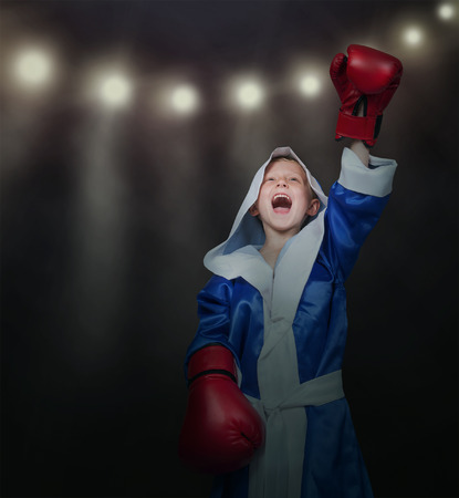 Happy vinner little boxer in ring lightsの写真素材