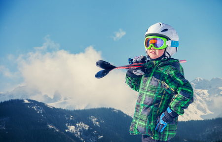 Young skier portrait in snowy mountainの写真素材