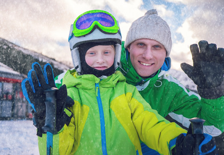 Father with son portrait on ski snow resortの写真素材