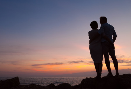 Loving couple sunset silhouetteの写真素材