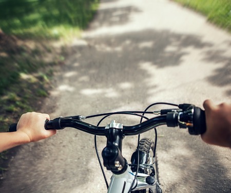 Handlebar with child hands close up imageの写真素材