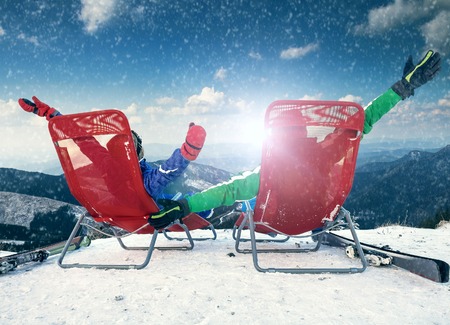 Two happy skiers on the top of mountainの写真素材