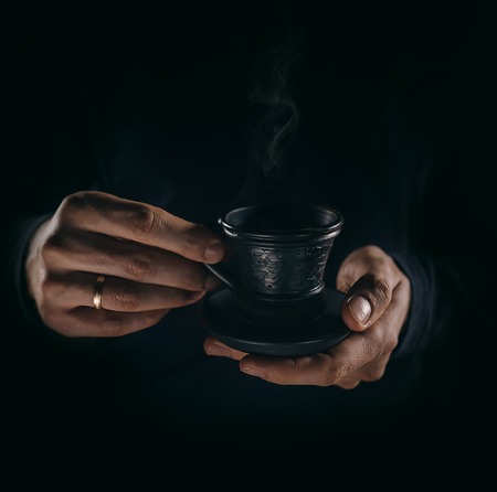 Man hands with cup of coffe close up imageの写真素材