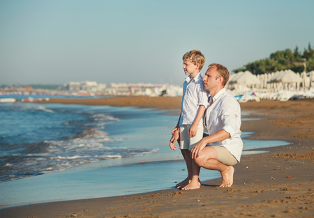 Father with son on the sea beachの写真素材