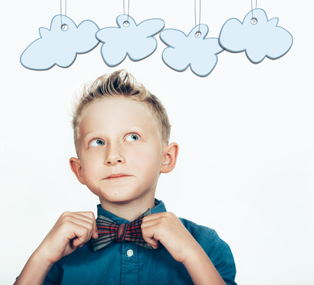 Little boy in the bow tie with cartoon clouds on whiteの写真素材