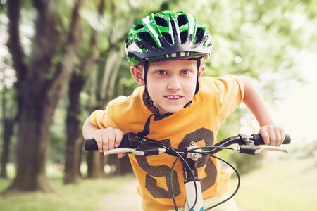 Happy little boy ride a bicycleの写真素材