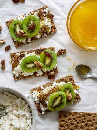 Healthy snack with cheese cottage, kiwi and honeyの写真素材