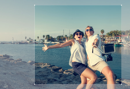 Funny couple take a selfie in the sea bayの写真素材