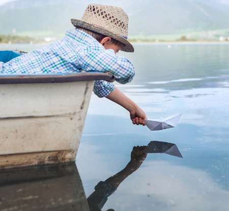 Boy hand with paper boat close up imageの写真素材