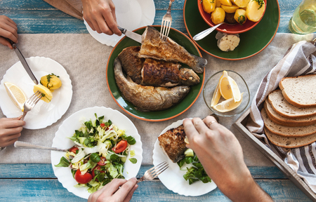 Dinner with fried fish, potatoes and fresh saladの写真素材