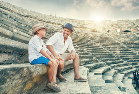 Father and son spent time together on antique ruins amphitheater Side,Turkeyの写真素材