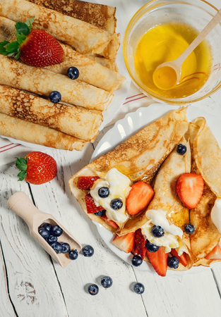 Homemade pancakes with wipped cream and fresh berriesの写真素材