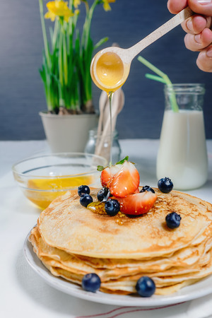 Homemade pancakes with fresh strawberry and honeyの写真素材