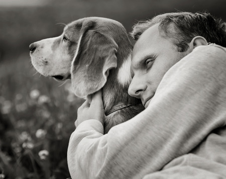 Man hugs his favorite dogの写真素材