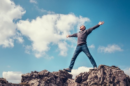 Man enjoy with freedom feel on the top of mountainの写真素材