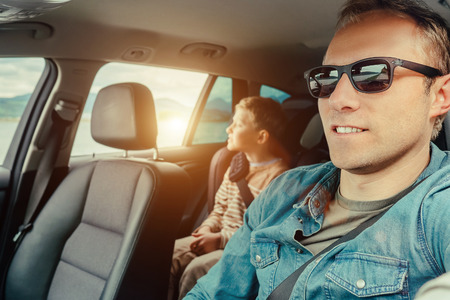 Father with son sit in carの写真素材