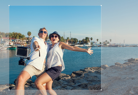 Funny couple take a selfie in the sea bayの写真素材