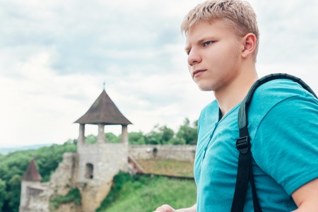 Young man tourist on the old castle territoryの写真素材
